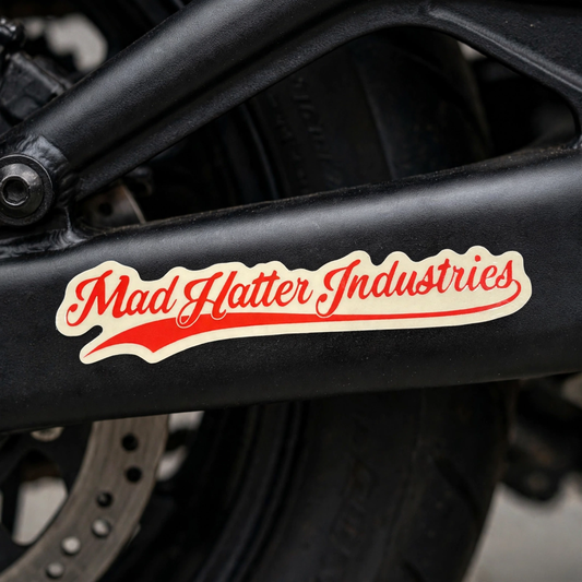 Mad Hatter Industries signature decal on a motorcycle swingarm